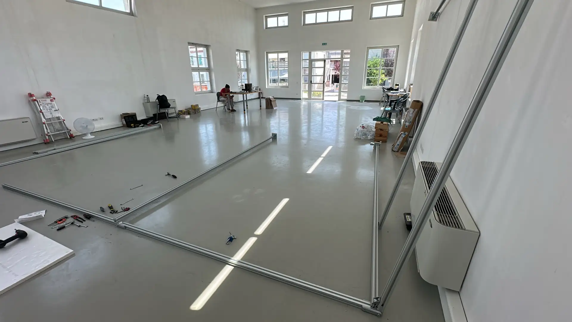 Aluminum Bosch Rexroth profiles laid out on the floor before assembly