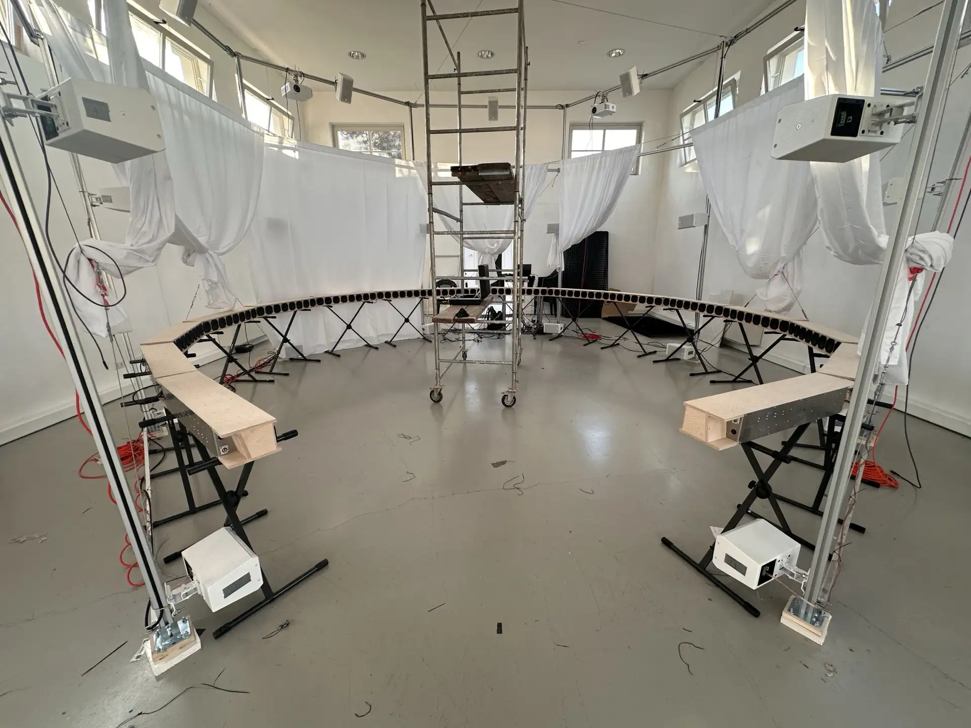The white projection screens gathered loosely like curtains